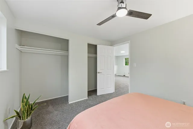 a bedroom with a bed and a potted plant
