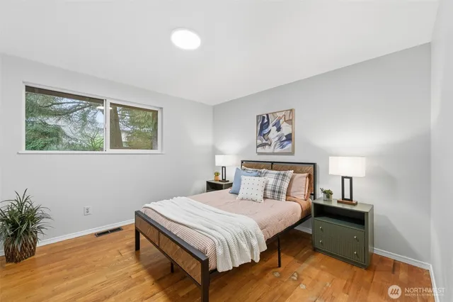 a bedroom with a bed and a painting on the wall