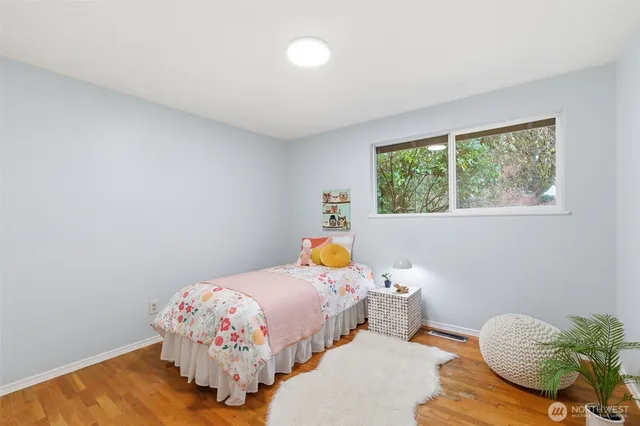 a bedroom with bed and a window