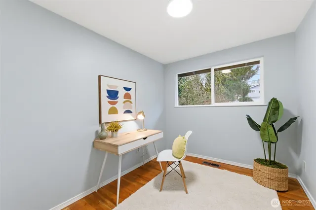 a work room with furniture and a potted plant