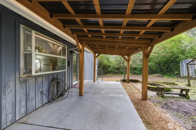 a view of a porch with a table and chairs