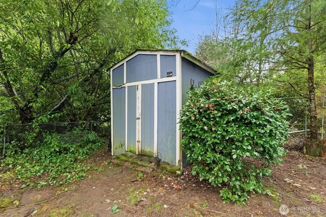 a backyard of a house with plants and tree