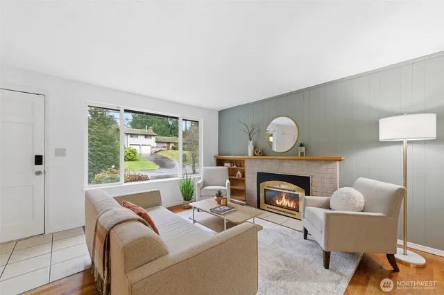 a living room with furniture a fireplace and a window