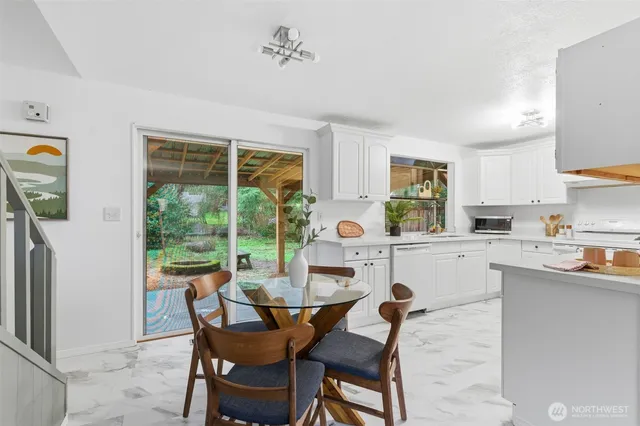 a kitchen with a table chairs and microwave