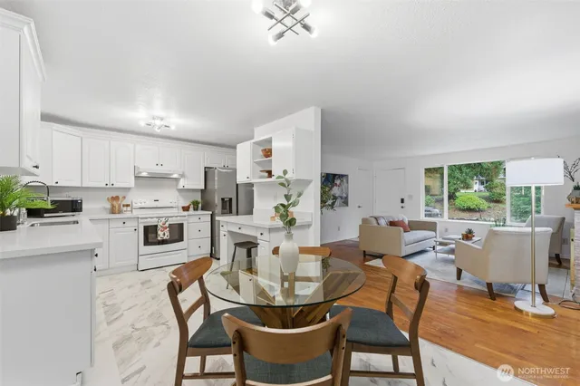 a dining room with furniture a window and kitchen view