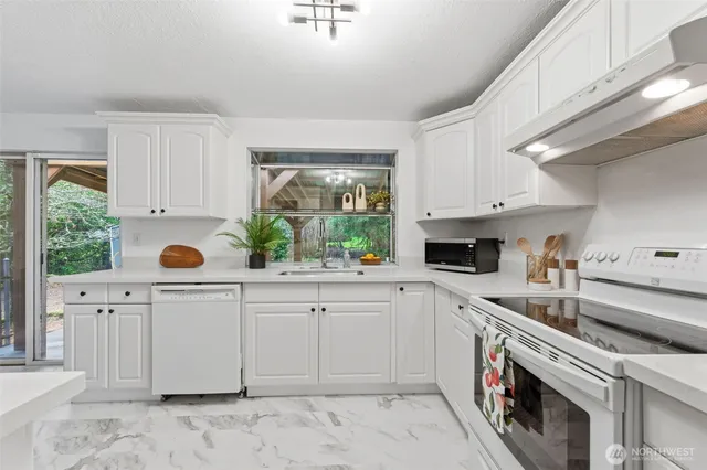 a kitchen with a sink cabinets and window
