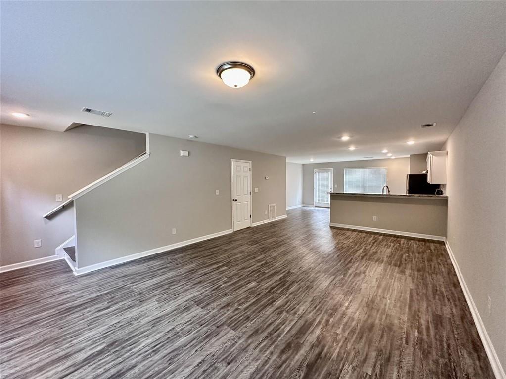 722 Keeshono St Union Union City, GA 30291 - Photo 2 of 7 a view of an empty room with wooden floor