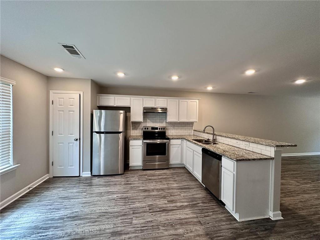 722 Keeshono St Union Union City, GA 30291 - Photo 3 of 7 a kitchen with stainless steel appliances granite countertop a refrigerator and a stove top oven