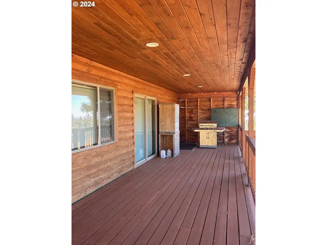 a big room with wooden floor and furniture