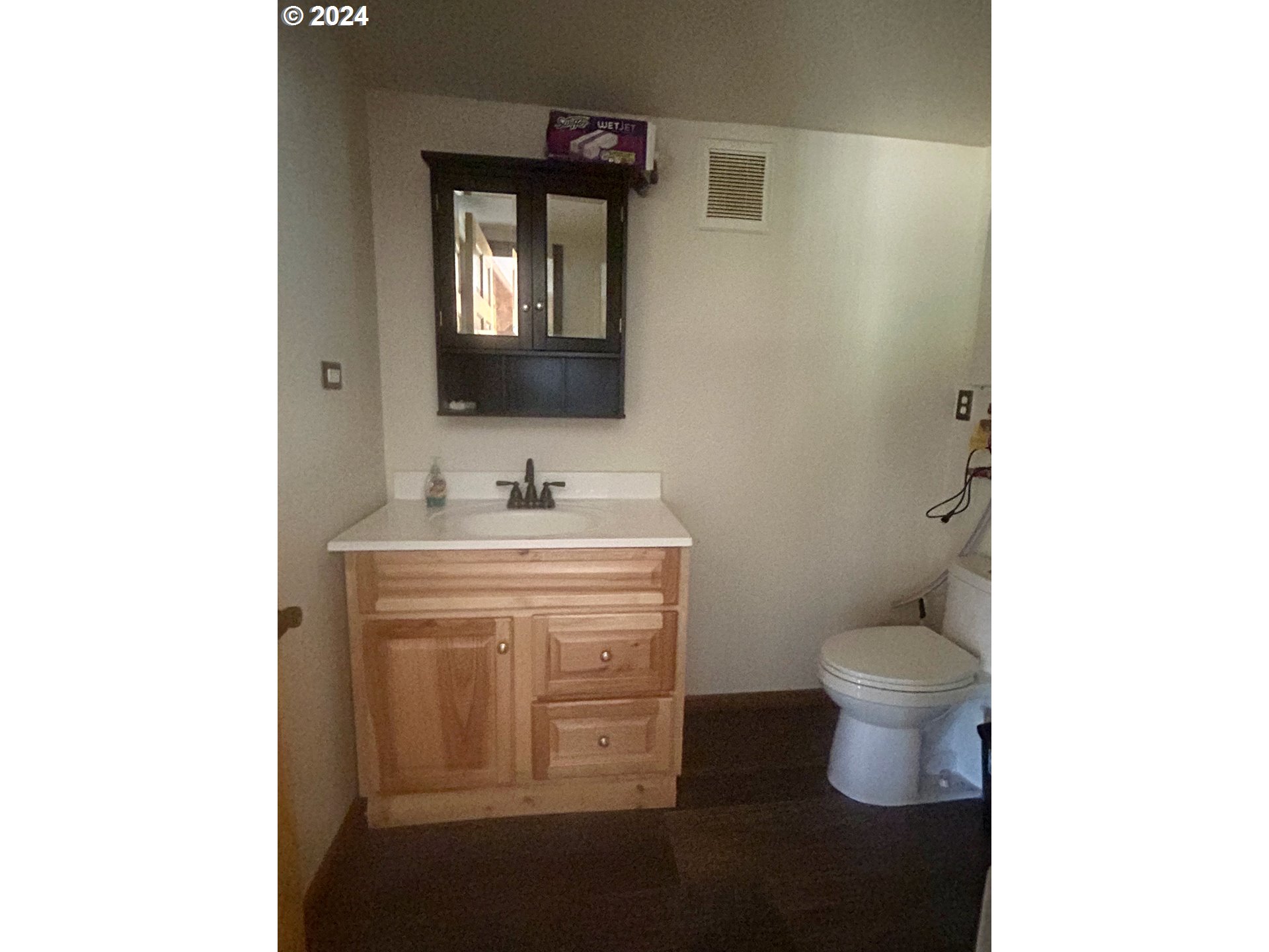 211 Jensen Quarry Road Roosevelt, WA 99356 - Photo 14 of 27 a bathroom with a toilet sink and mirror