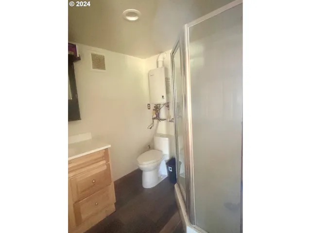 a bathroom with a toilet and a shower