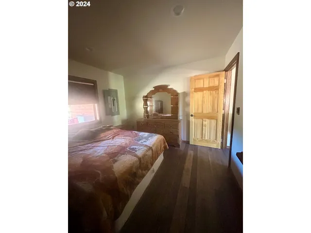 a bedroom with a bed and a large window