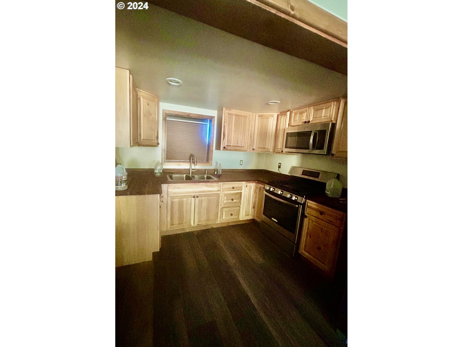 211 Jensen Quarry Road Roosevelt, WA 99356 - Photo 20 of 27 a kitchen with stainless steel appliances granite countertop a stove a sink and a refrigerator