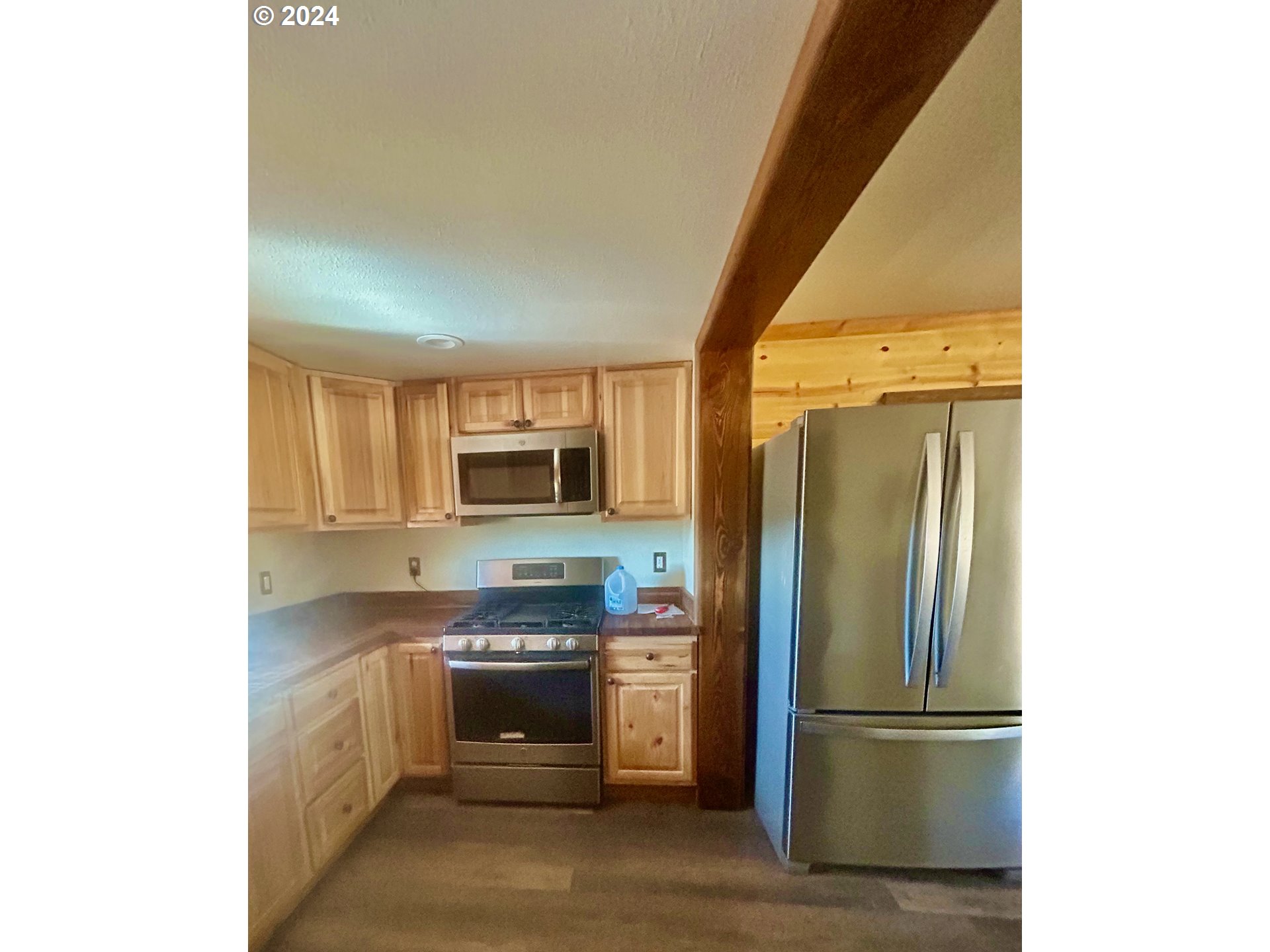 211 Jensen Quarry Road Roosevelt, WA 99356 - Photo 21 of 27 a kitchen with stainless steel appliances granite countertop a refrigerator and a sink