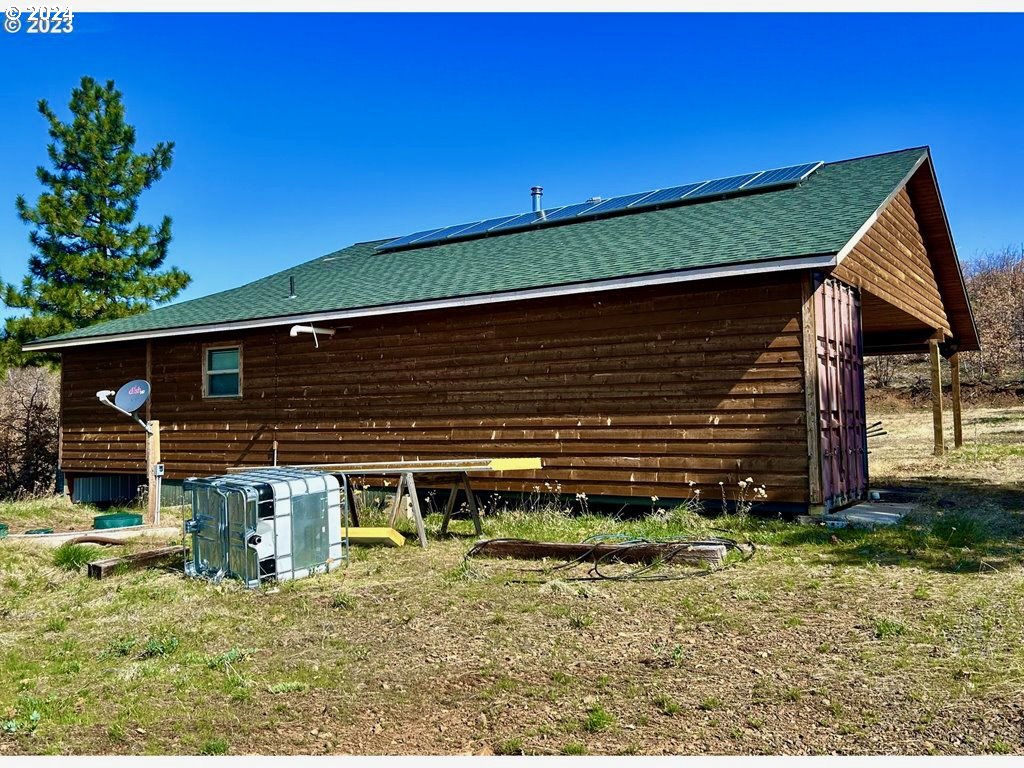 211 Jensen Quarry Road Roosevelt, WA 99356 - Photo 3 of 27 a backyard of a house with plants and wooden fence