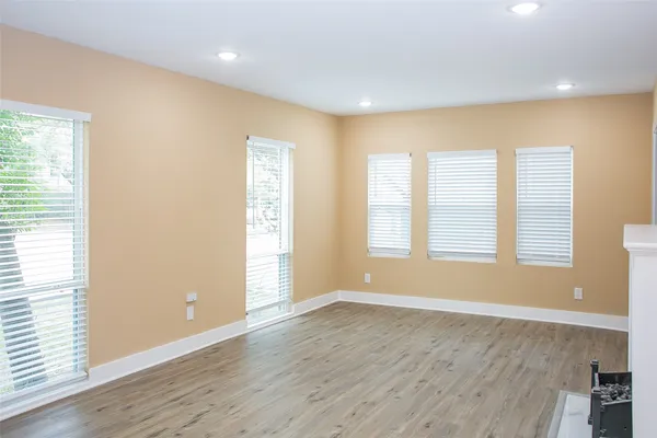 a view of wooden floor and windows in a room