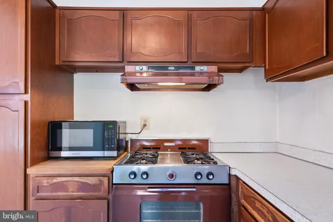 a stove top oven sitting inside of a kitchen