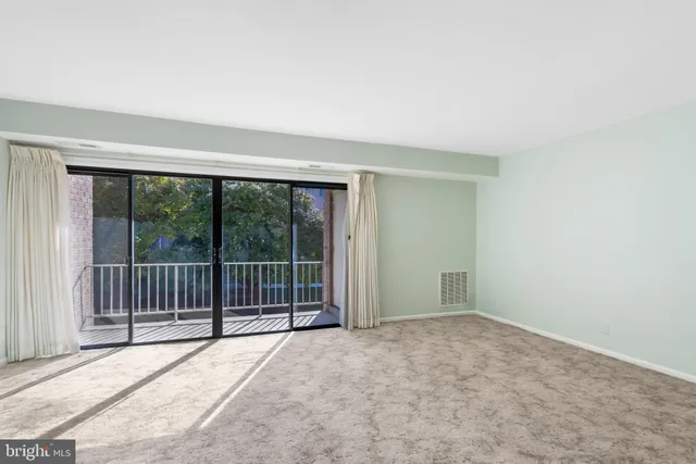 en empty room with sliding door and wooden floor