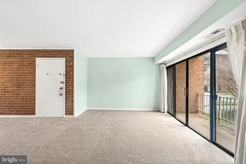 a view of an empty room with a large window