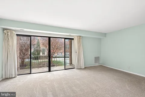a view of empty room with floor to ceiling window