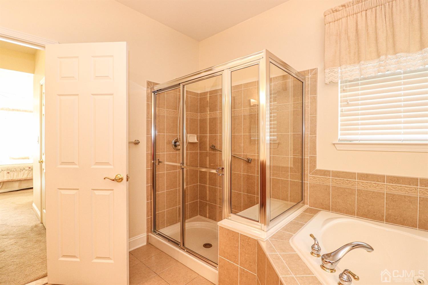 8 Pebble Creek Road Dayton, NJ 08810 - Photo 13 of 19 a bathroom with a bathtub and a shower