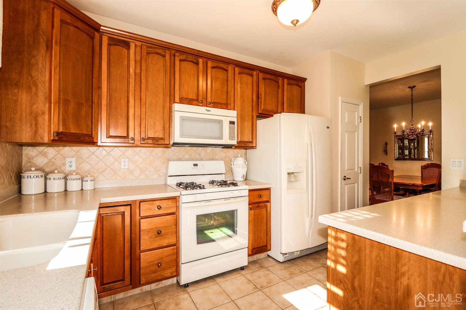 8 Pebble Creek Road Dayton, NJ 08810 - Photo 6 of 19 a kitchen with a stove a refrigerator and a sink