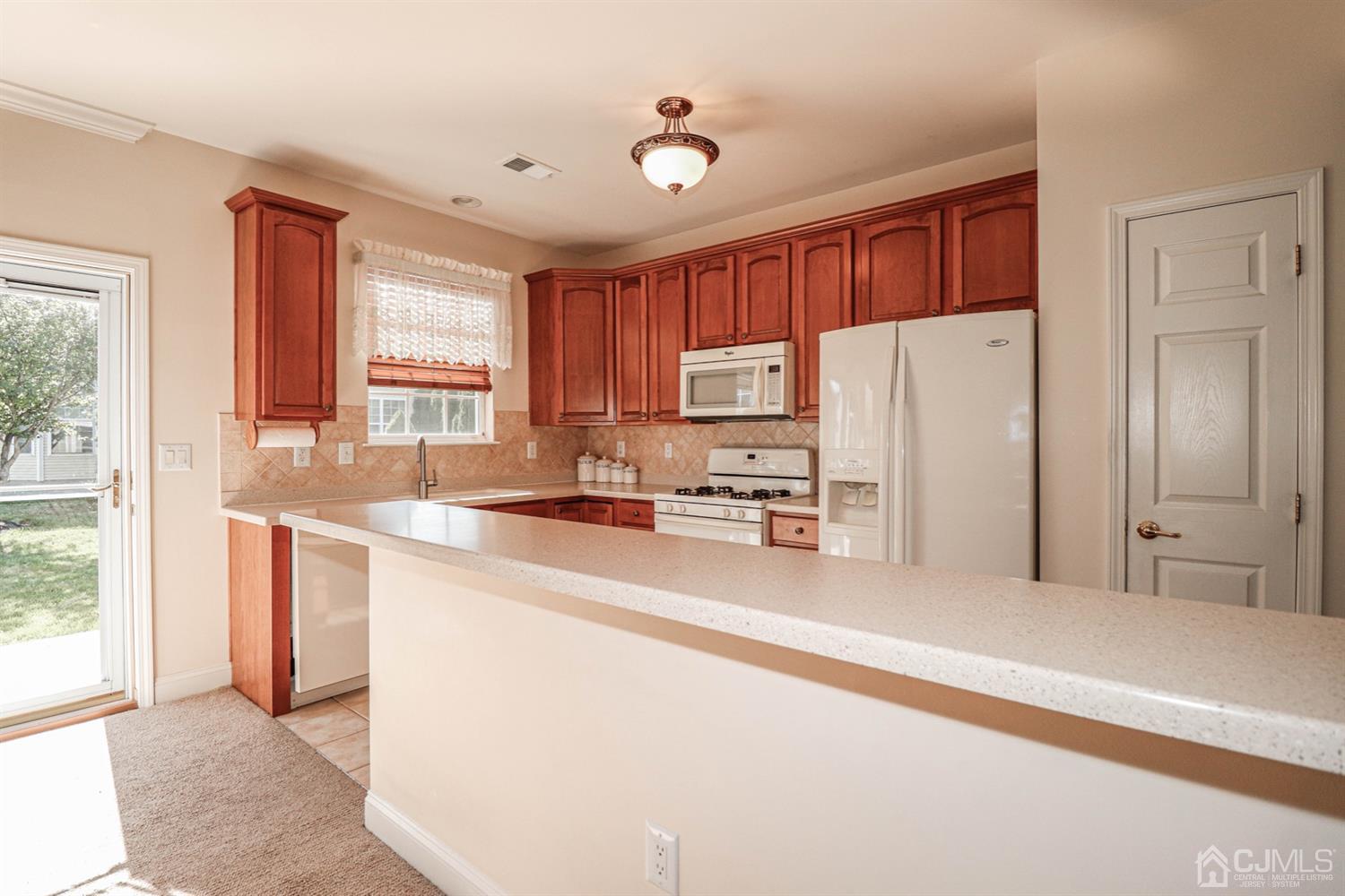 8 Pebble Creek Road Dayton, NJ 08810 - Photo 7 of 19 a kitchen with stainless steel appliances granite countertop a refrigerator sink and cabinets