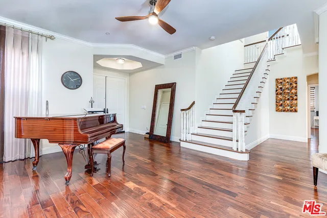 a living room with wooden floor and furniture