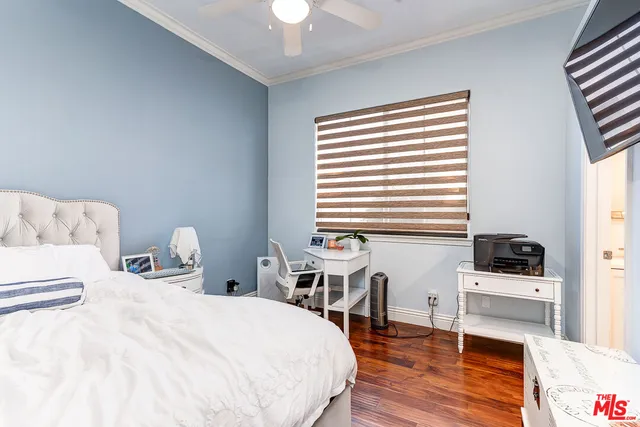 a bedroom with furniture and a wooden floor