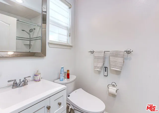 a bathroom with a sink a toilet and vanity