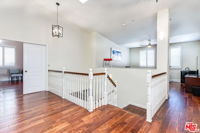 a view of a kitchen with wooden floor and electronic appliances