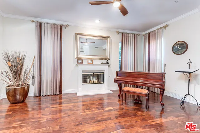 a living room with furniture a fireplace and a potted plant