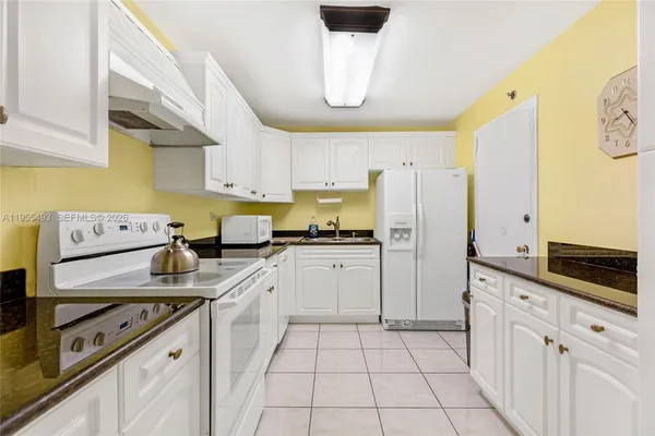 a kitchen with a sink a stove and cabinets