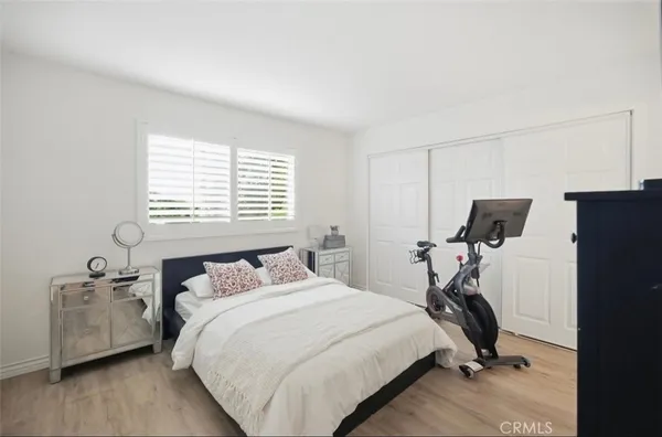a bedroom with a bed and a tv