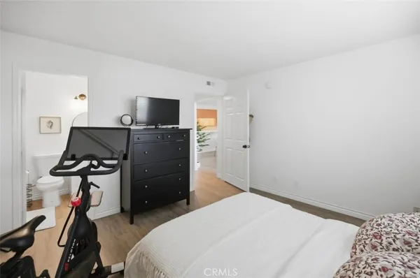 a bedroom with a bed and cabinets