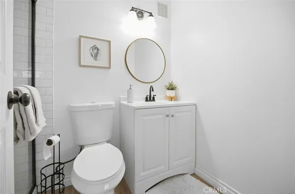 a bathroom with a toilet a sink and a mirror