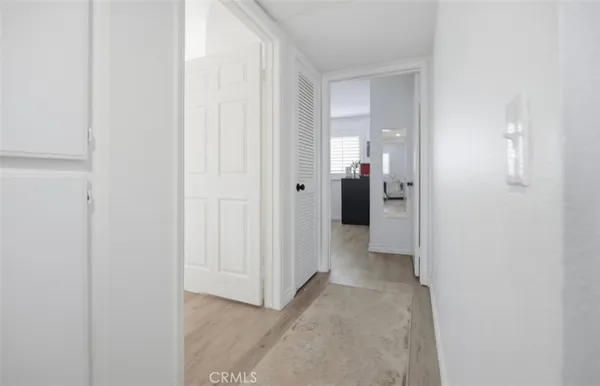 a view of a hallway with wooden shelves