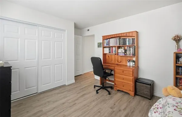 a view of a workspace with furniture and wooden floor