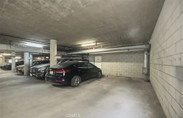 a view of parking garage with cars parked