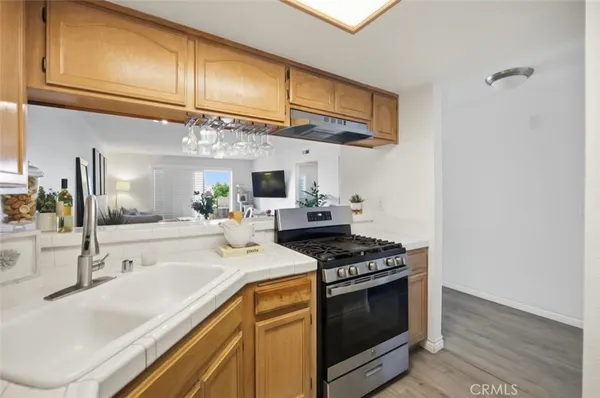 a kitchen with stainless steel appliances granite countertop a sink stove and cabinets