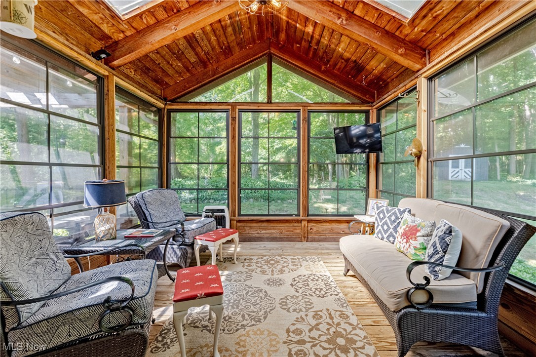 8062 Chagrin Road Chagrin Falls, OH 44023 - Photo 17 of 50 Tucked just off the kitchen and dining area, this 3-season room is the perfect cozy retreat for morning coffee or winding down after a long day. Surrounded by warm wood and floor-to-ceiling windows, it brings nature inside—whether it’s enjoying colorful fall leaves or a quiet winter snowfall.It’s no surprise this space quickly becomes everyone’s favorite.
