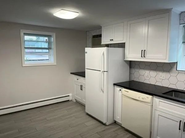 a white refrigerator freezer sitting inside of a kitchen