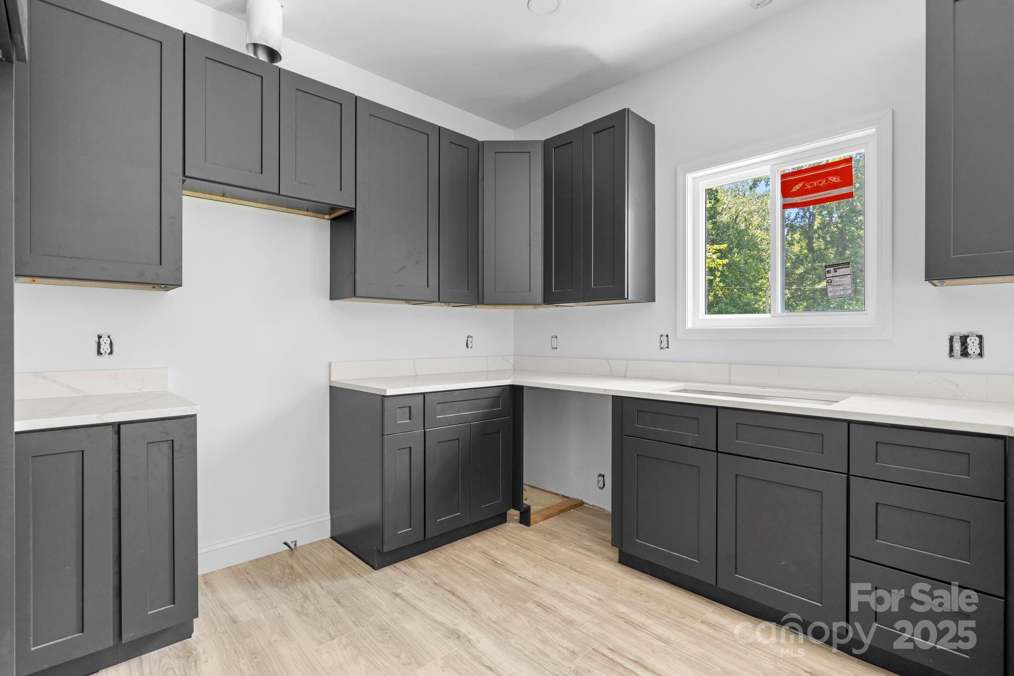 3137 Riber Lane Claremont, NC 28610 - Photo 11 of 25 a kitchen with wooden cabinets and sink