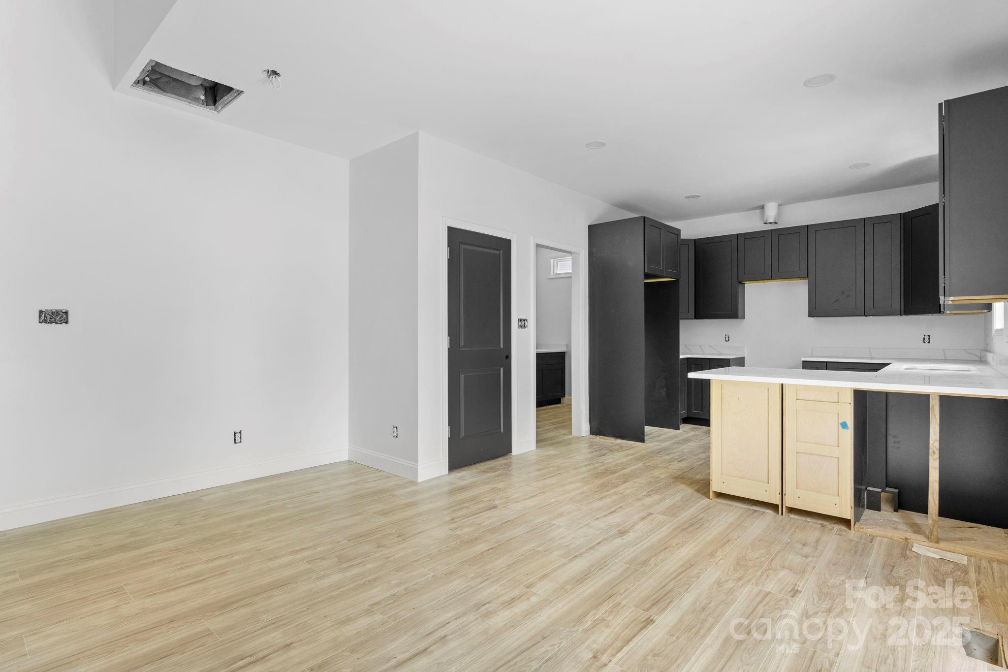 3137 Riber Lane Claremont, NC 28610 - Photo 9 of 25 a view of a kitchen with white cabinets and wooden floor