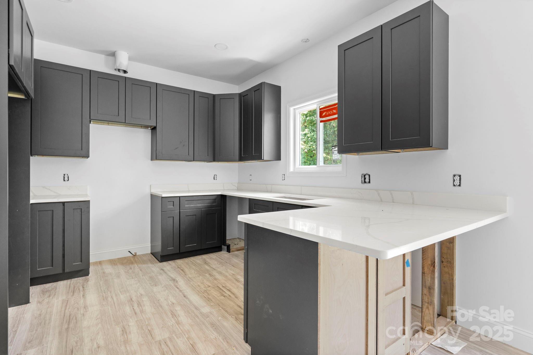 3137 Riber Lane Claremont, NC 28610 - Photo 10 of 25 a kitchen with a sink cabinets and wooden floor