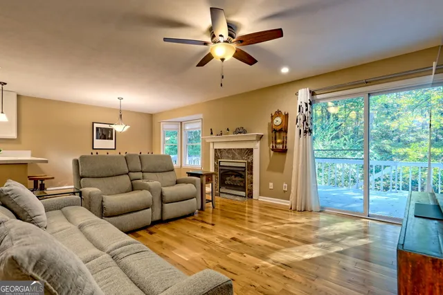 a living room with furniture large window and flat screen tv