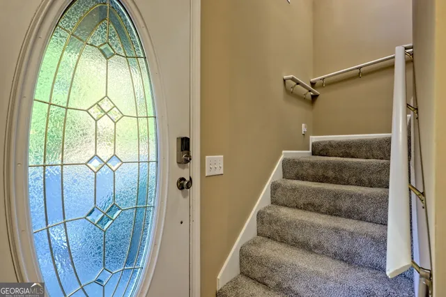 a kitchen with a table chairs sink and cabinets
