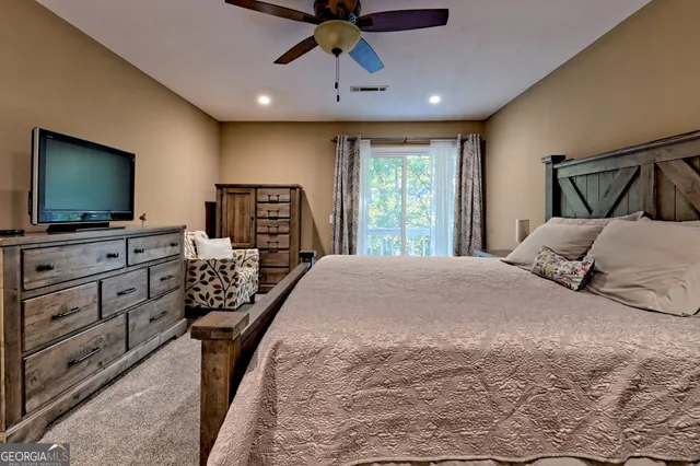 a spacious bedroom with a bed and a chandelier