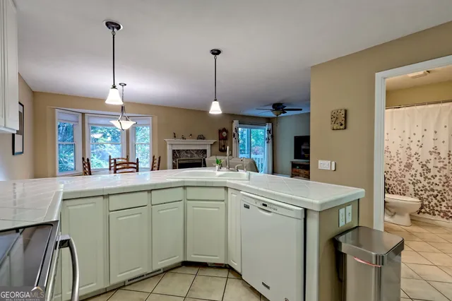 a kitchen that has a sink a stove and a table