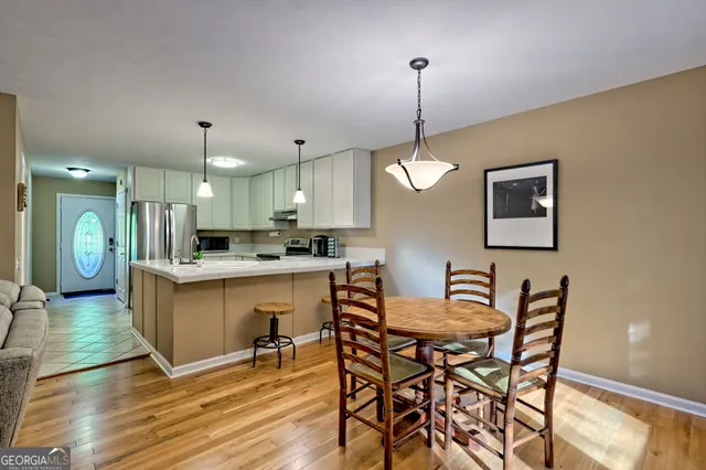 a large kitchen with a table and chairs